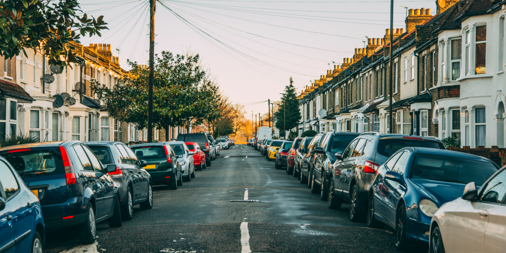 Protecting empty properties during summer: an empty london street with houses on either side and cars parked all along the side of the road